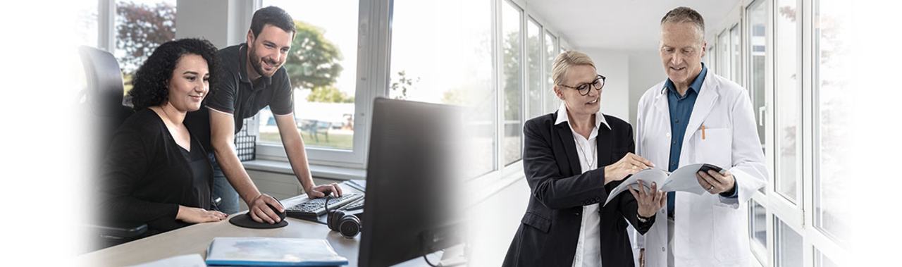 The image shows two groups of people in different settings. On the left, a woman and a man are engaging with a computer. On the right, a woman in business attire discusses a document with a man in a white lab coat, suggesting a professional collaboration.